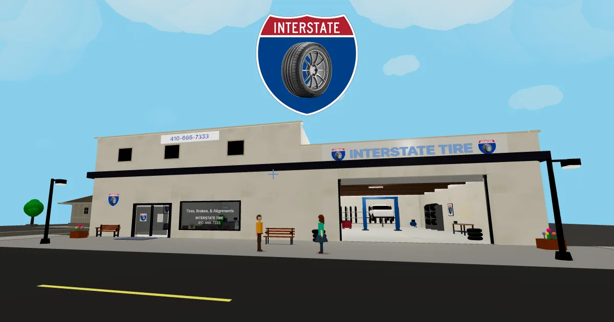 A 3D tire shop storefront with an open garage bay beneath the Interstate Tire sign.
