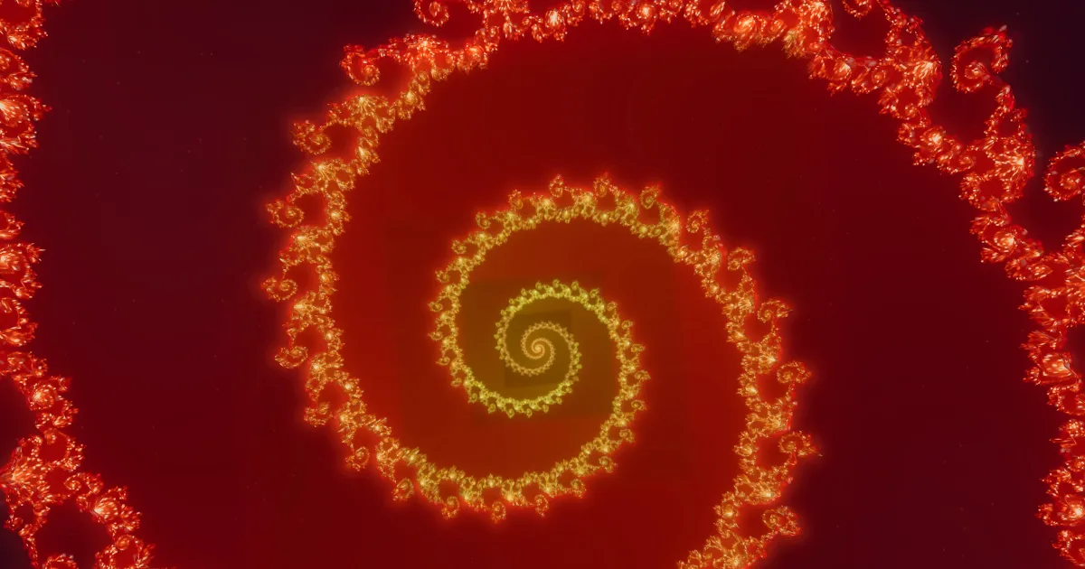 A deep zoom into the Mandelbrot set: a giant spiral of glowing red and gold fractal filaments coiling toward its center against dark space.